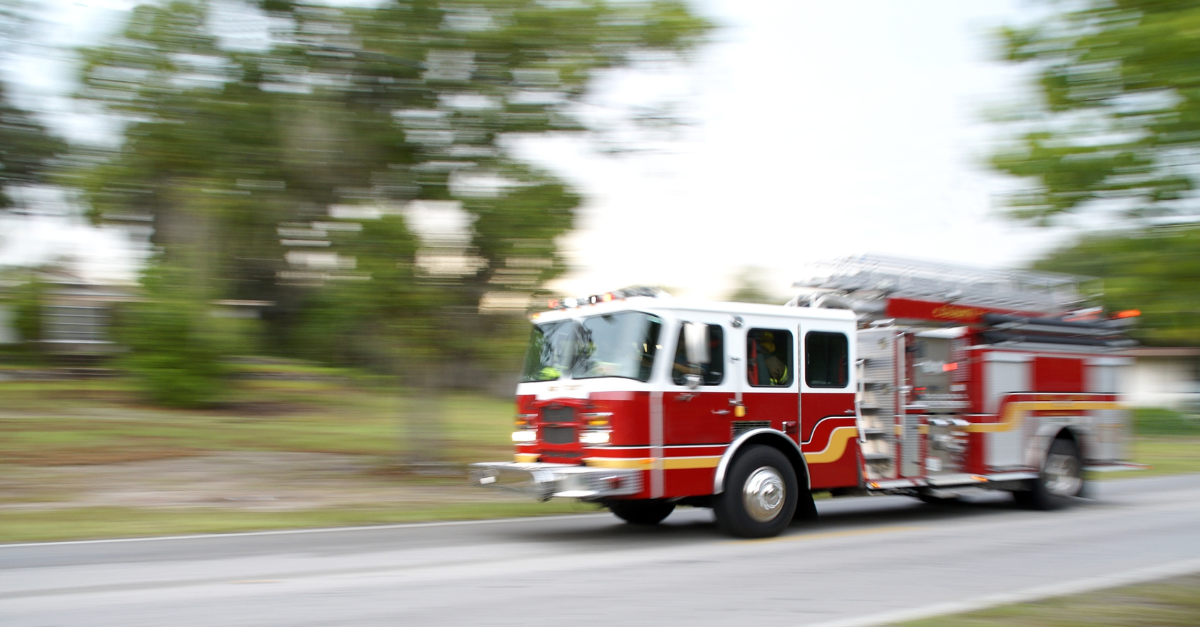 Updated AugSept Packerland LinkedIn Ads-5 A firetruck is shown in blurred motion as it races along a rural road