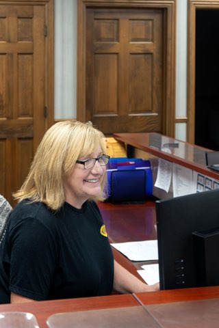 A Packerland team member smiling at the front desk.