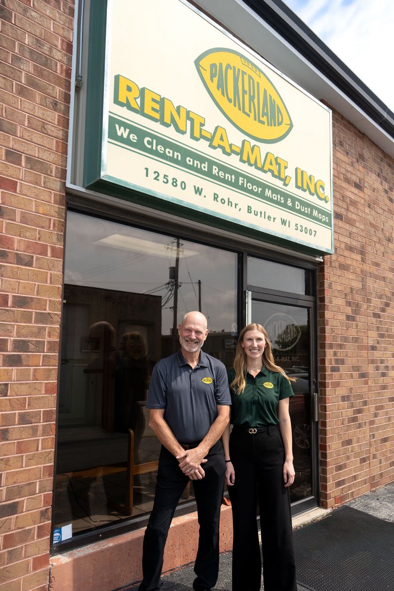 The Packerland Rent-A-Mat office in Butler, Wisconsin, with two team members out front.