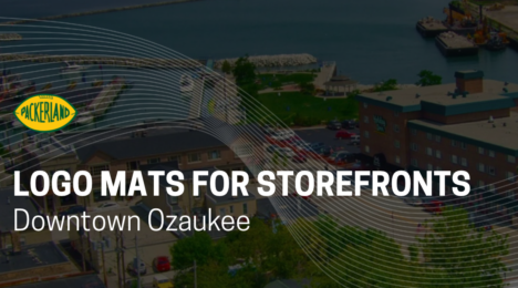 Packerland graphic titled “Logo Mats for Storefronts – Downtown Ozaukee” over an aerial view of downtown Port Washington, WI and its Lake Michigan harbor.