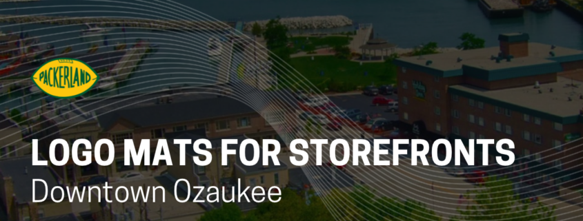 Packerland graphic titled “Logo Mats for Storefronts – Downtown Ozaukee” over an aerial view of downtown Port Washington, WI and its Lake Michigan harbor.